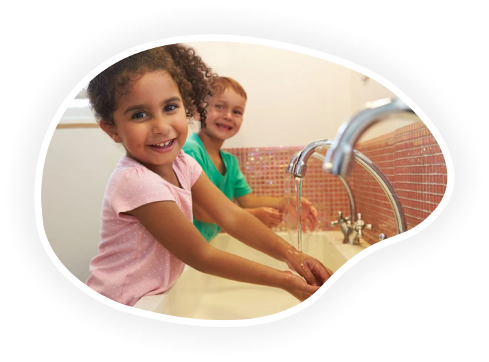 Children washing their hands in a sink