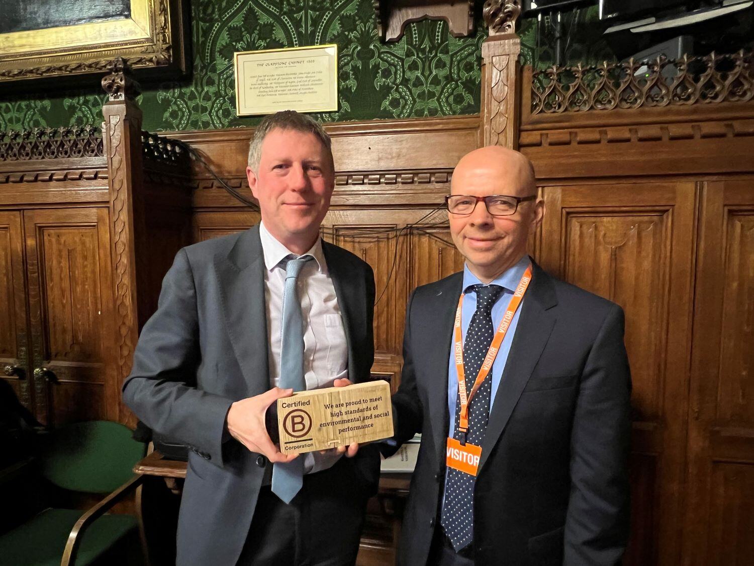 Managing Director Nicholas Parrish is presented with the B Corp award at the Houses of Parliament by MP for Lewes James MacCleary.